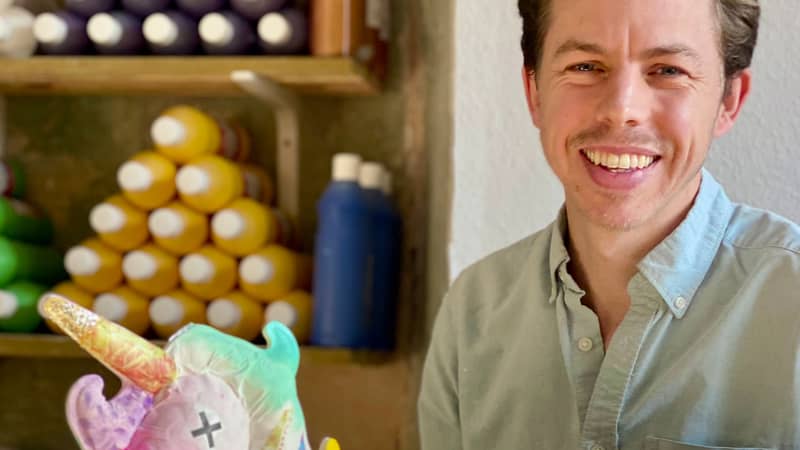 Founder, Ben Strange, in the workshop with a completed unicorn model.