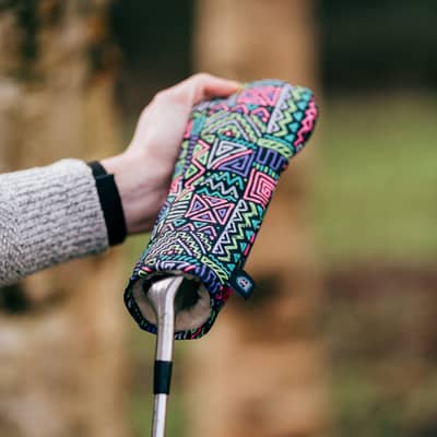 A head cover being removed from a club.