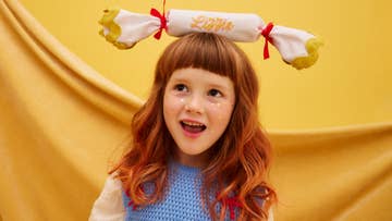 girl balancing a cracker on her head