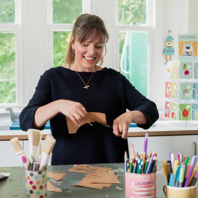 All of our designs begin with hand cut paper collages.