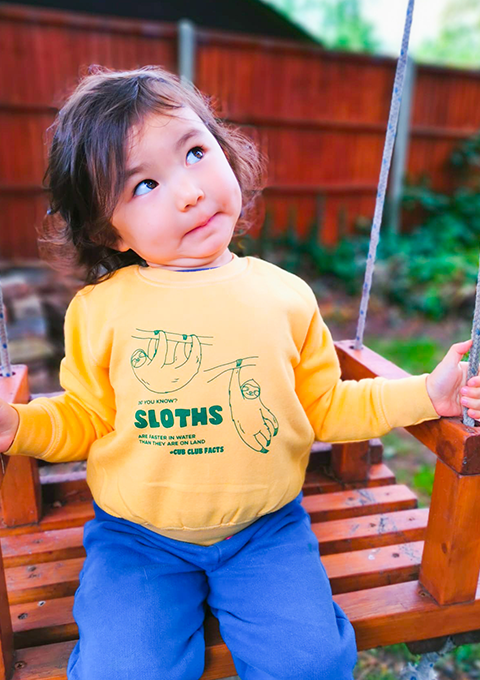 Baby wearing our sloth fact sweatshirt