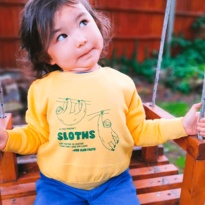 Baby wearing our sloth fact sweatshirt