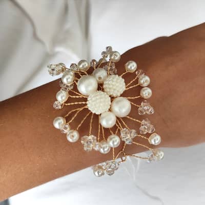 This beautifully handcrafted wedding corsage exudes timeless elegance and sophistication. It features an intricate arrangement of lustrous pearl beads and delic