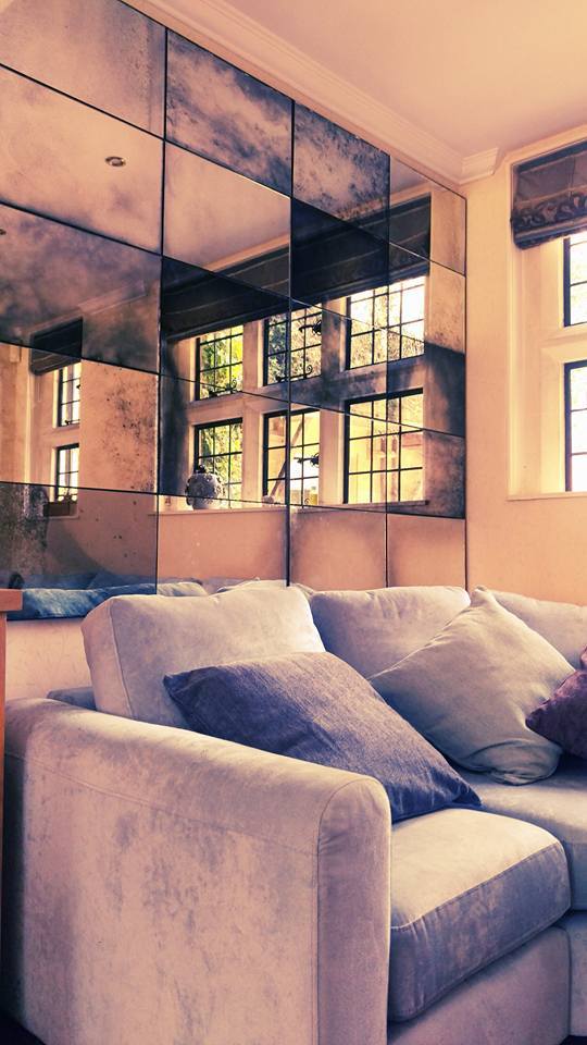 This is an antique foxed mirror panelled bespoke piece. It was made specifically to fit the customers dimensions.