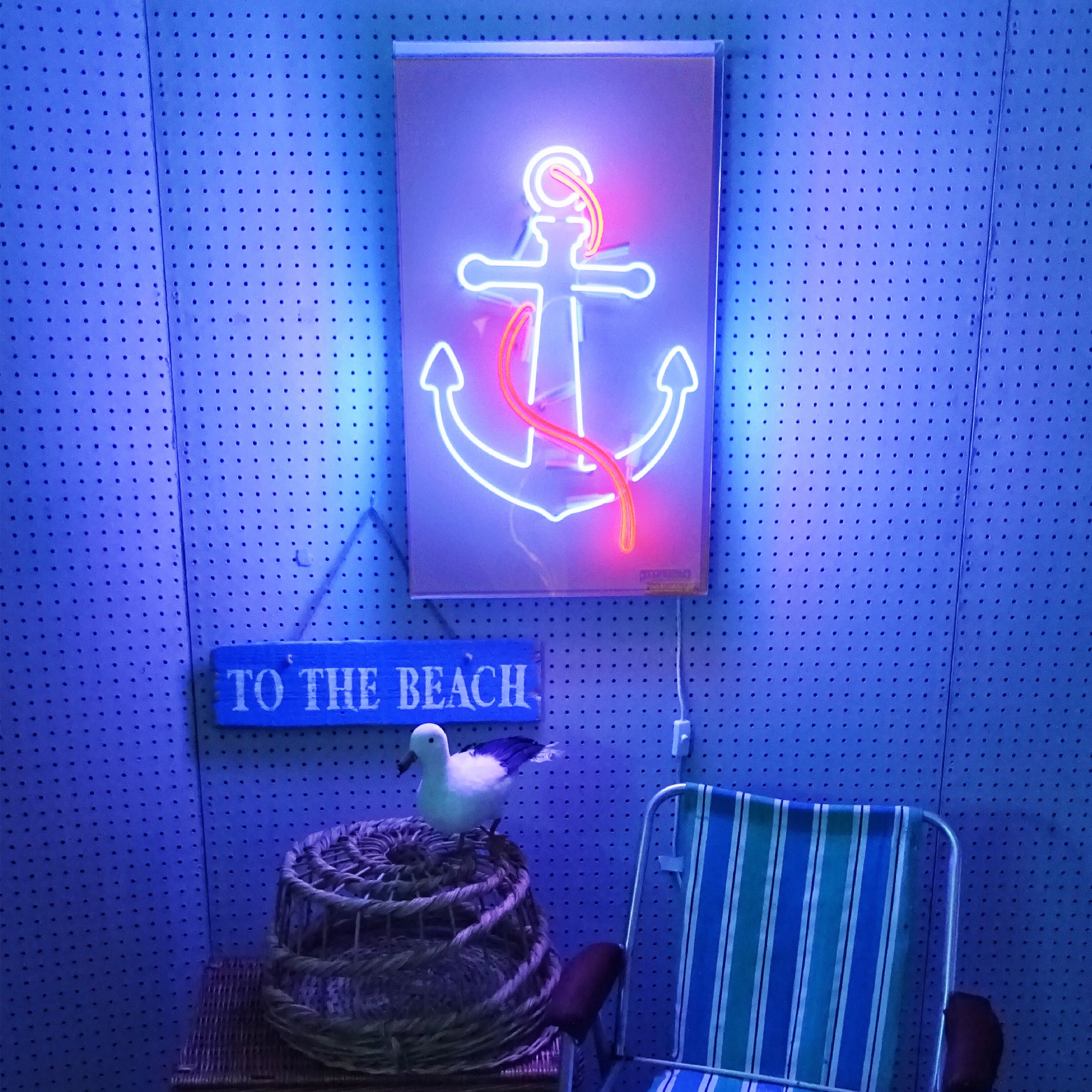 Blue anchor with red rope real glass neon sign on a white background 