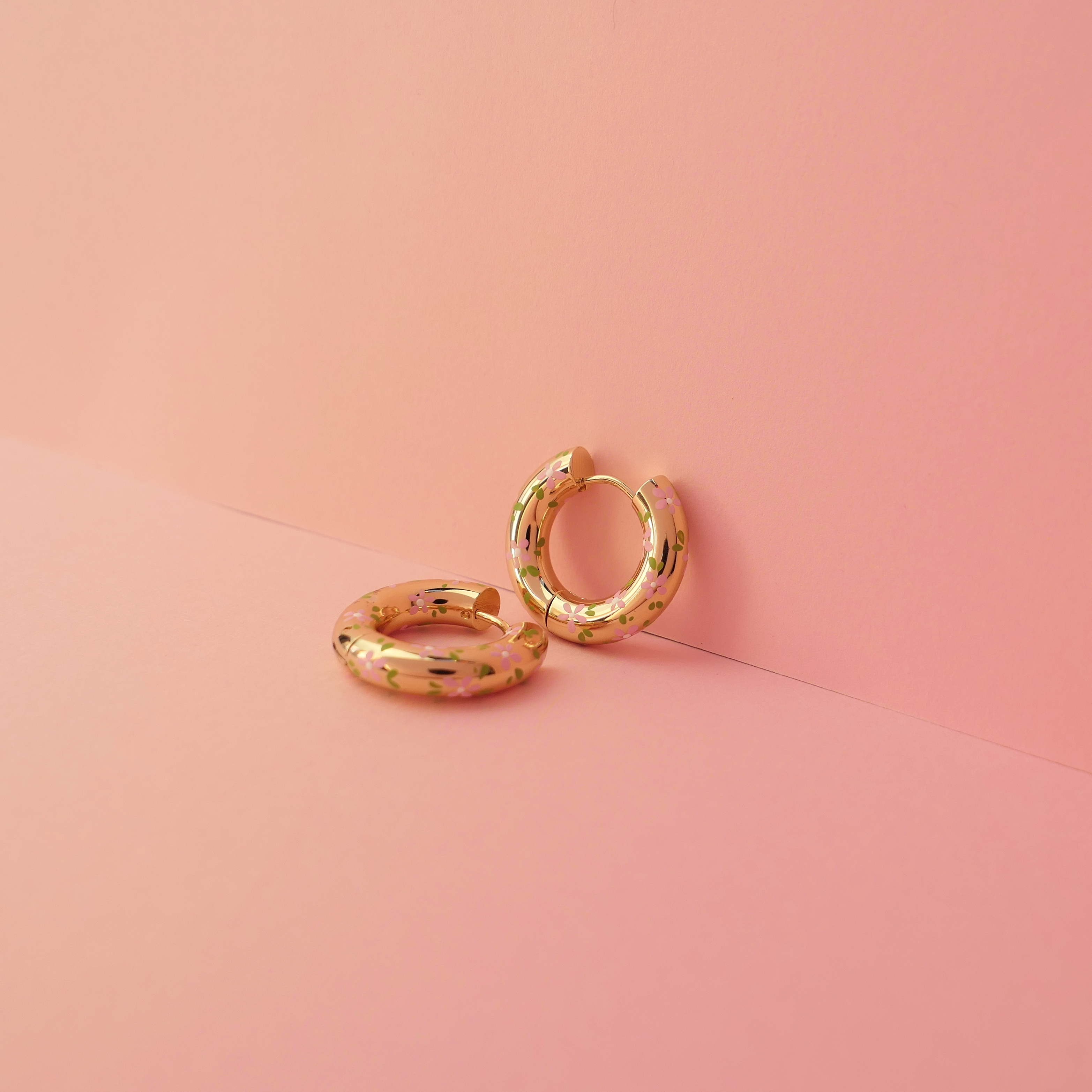 Chunky gold hoop earrings in an ear