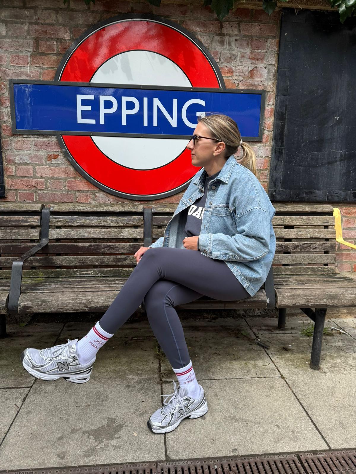 sitting next to tube sign