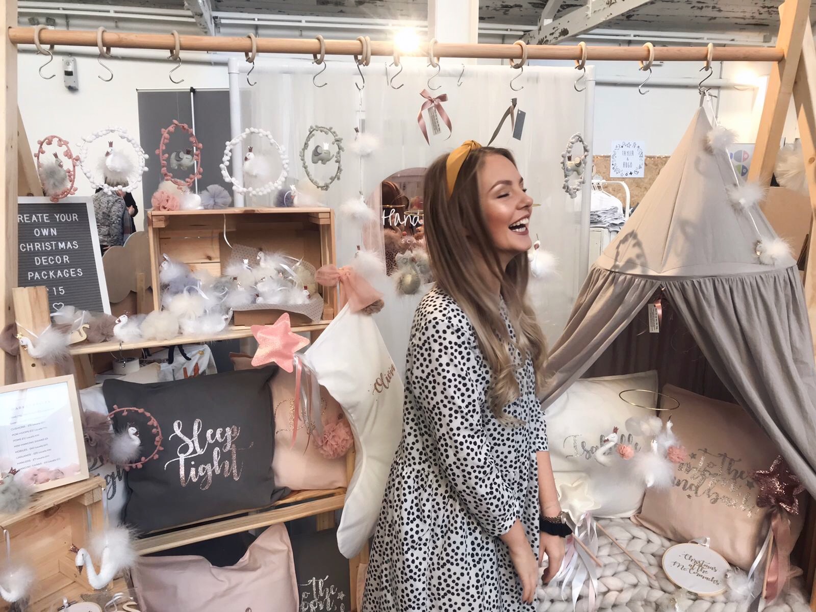 small business owner at an independent makers market selling children's decor accessories