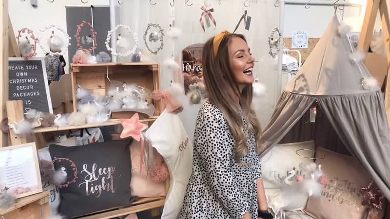 small business owner at an independent makers market selling children's decor accessories