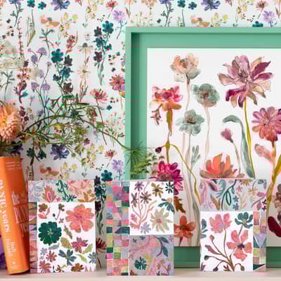 A collection of Floradore's Quilted Blooms greetings cards against Floradore wallpaper.