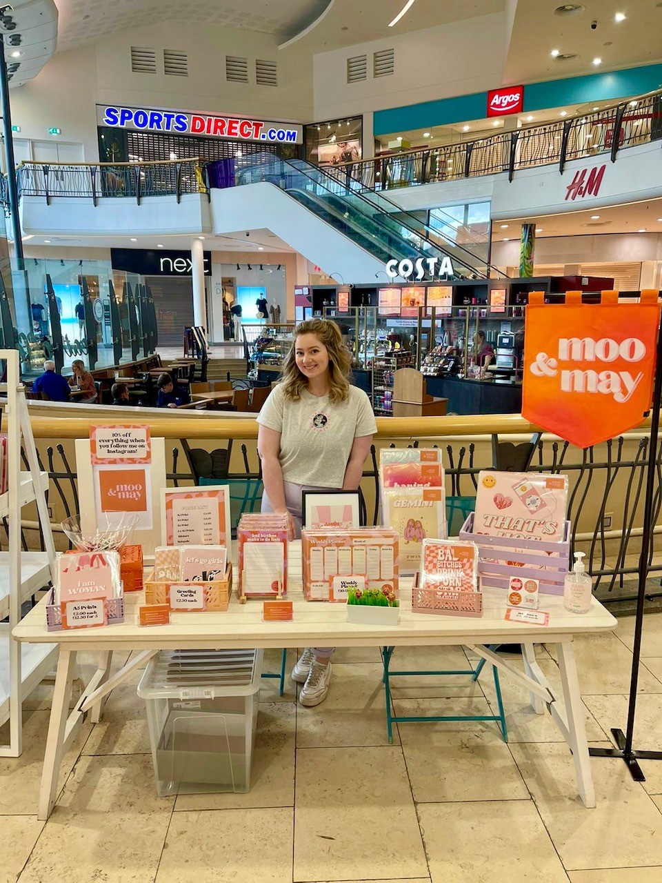 Jess standing with a Moo & May stall
