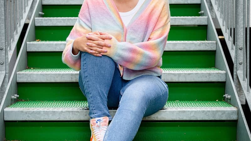 The Joyful Rebel owner sitting on green steps