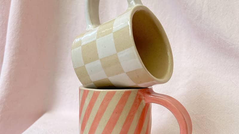 Two geometric pattern mugs stacked up on top of each other.