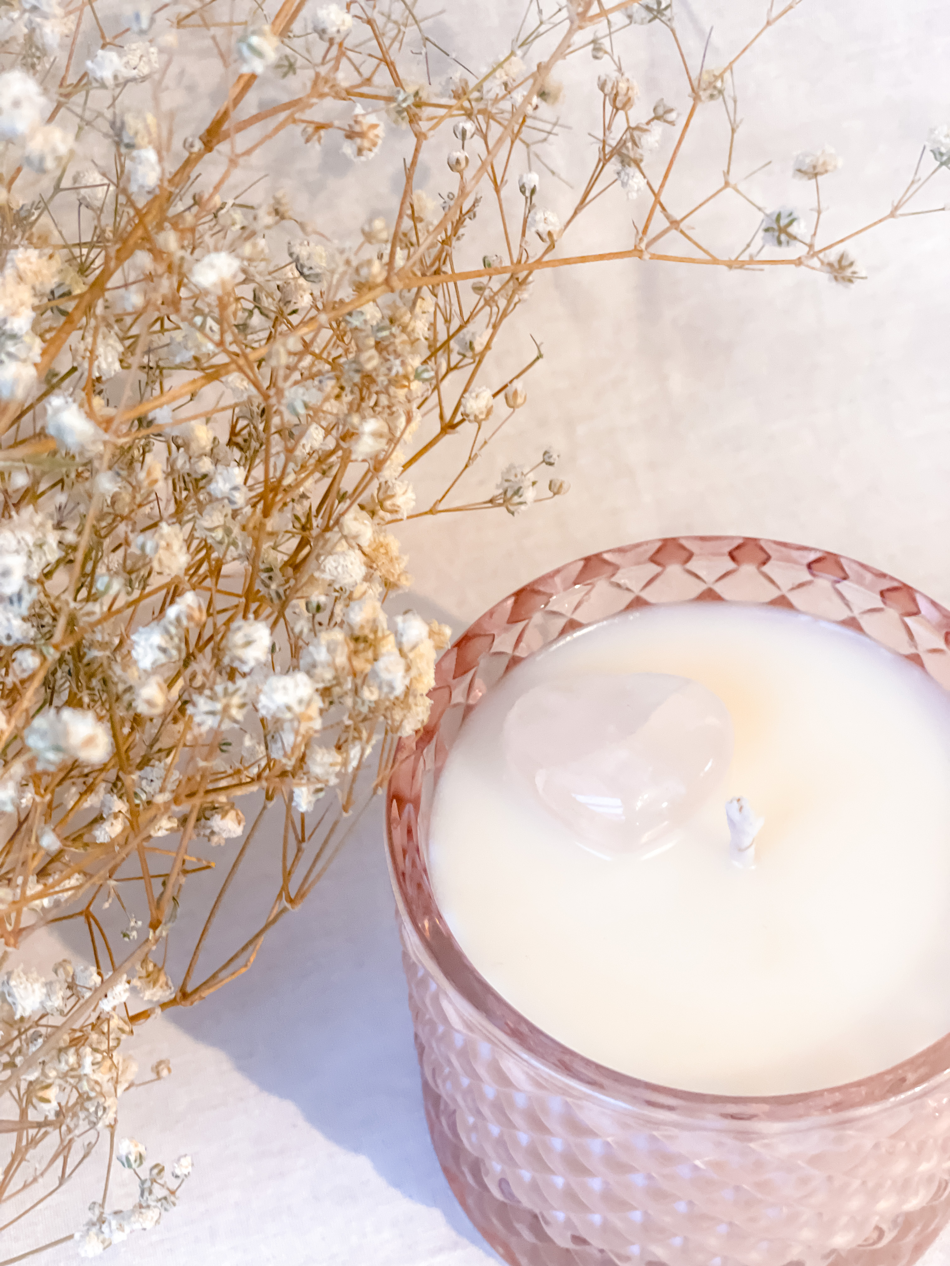 Pink candle with heart crystal infused.