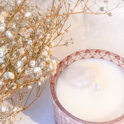 Pink candle with heart crystal infused.