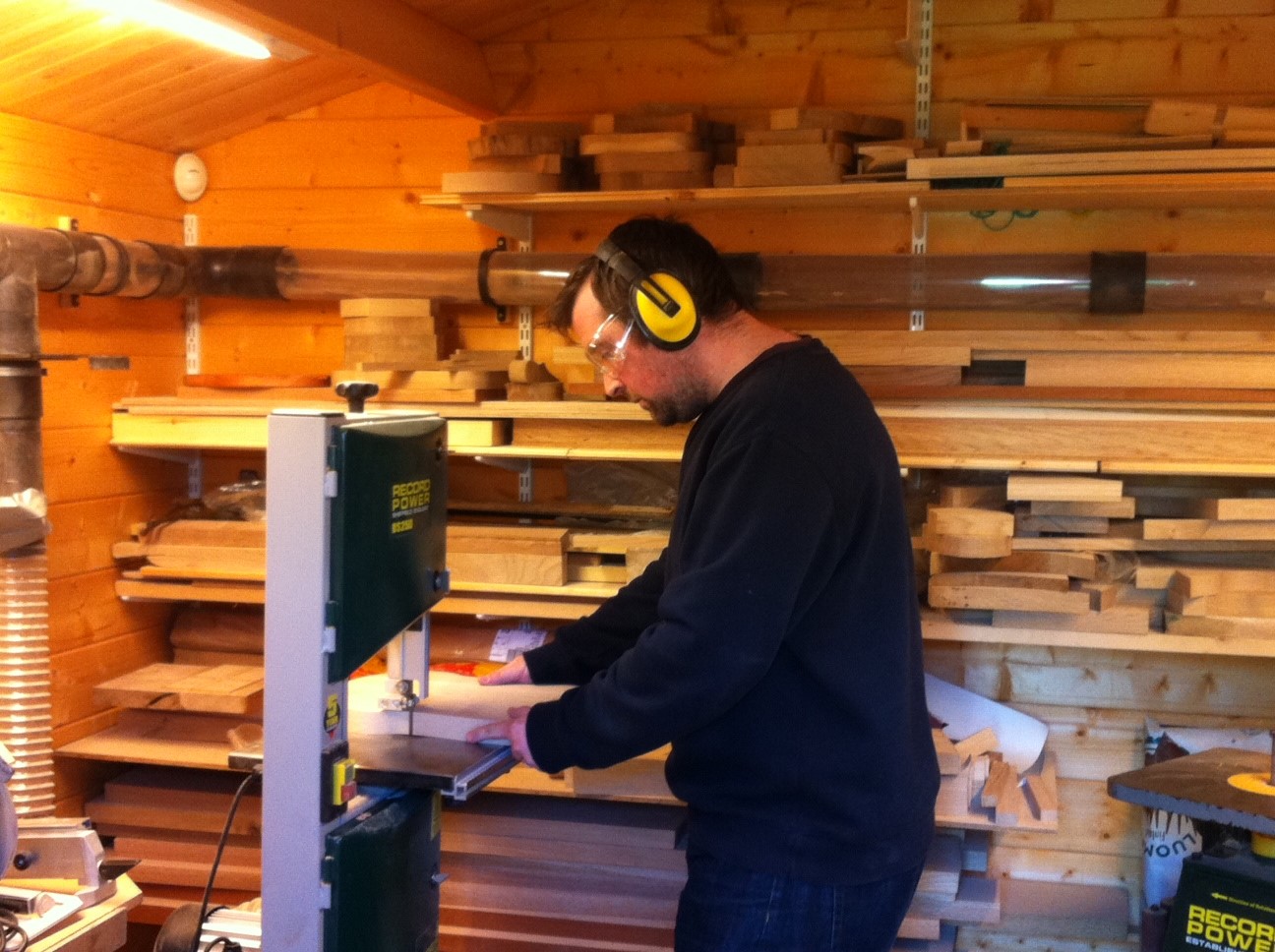 Joe in our first workshop, a 3m by 3m log cabin at the end of our garden.