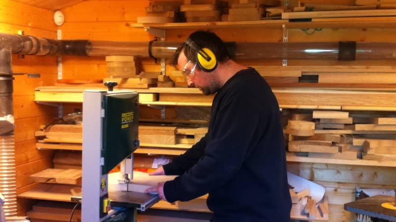 Joe in our first workshop, a 3m by 3m log cabin at the end of our garden.