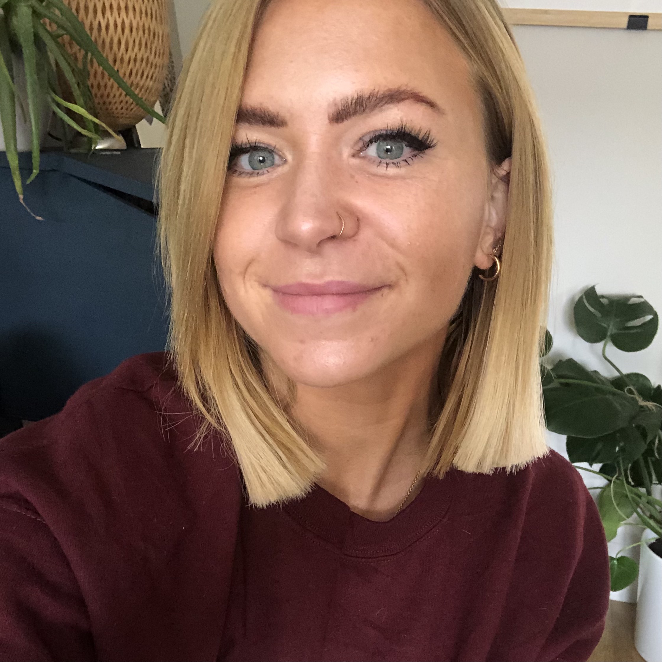 This is Ellie, she is the owner of Elle&Co. She has short blond hair and is smiling.