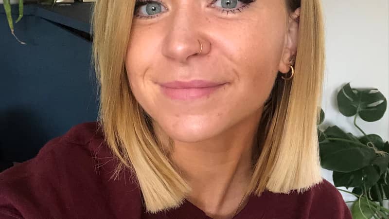 This is Ellie, she is the owner of Elle&Co. She has short blond hair and is smiling.