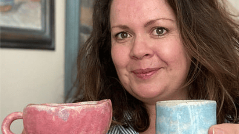 Maker with a teacup and espresso cup in hand