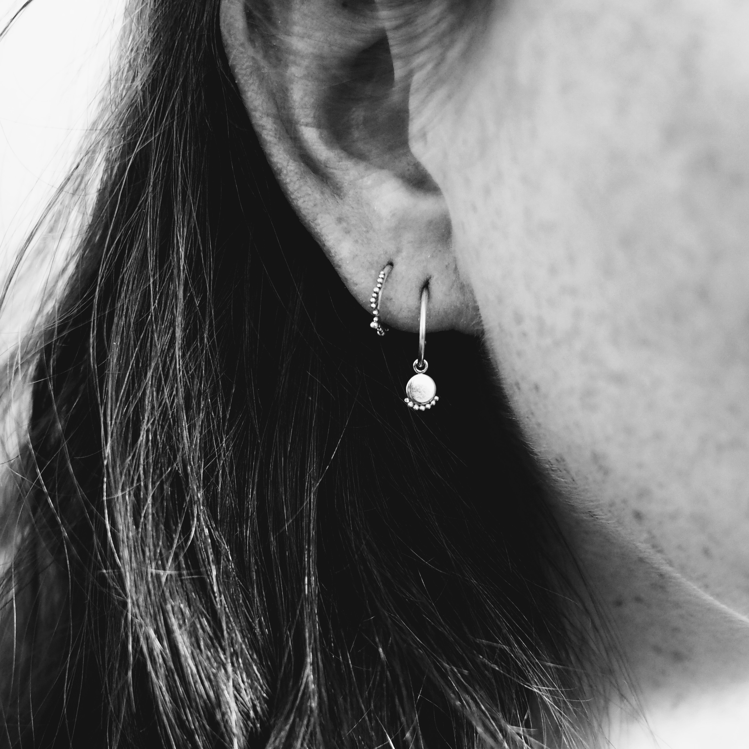 Kate wainwright jewellery making jewellery rae charm hoops and sol huggies worn in black and white