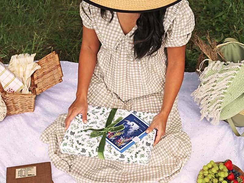 girl holding making meadows wrapping paper