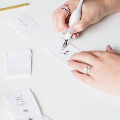 White Olive Design Studio modern calligraphy wedding place settings