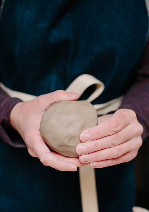 Pottery making techniques forming clay into a ball