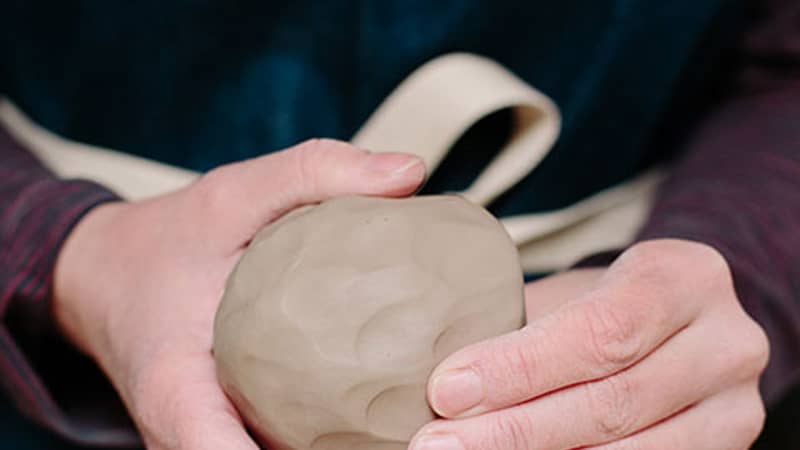 Pottery making techniques forming clay into a ball