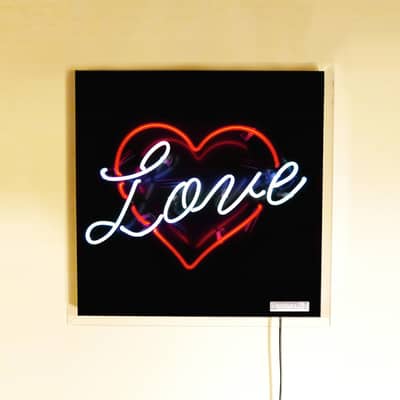 2 colour neon sign, 'love' written in red heart, real glass neon sign on a black background