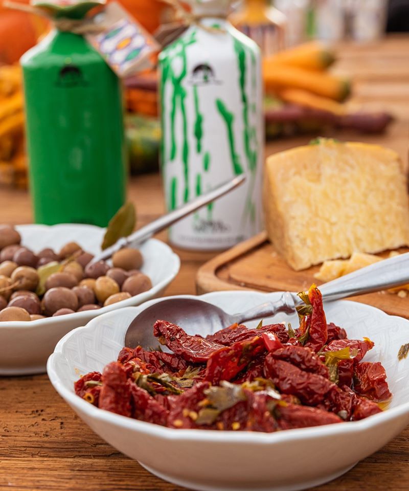 A selection of our hand made, hand painted patterned terracotta jars with our organic extra virgin olive oil. Marinated vegetables from our farm in Puglia