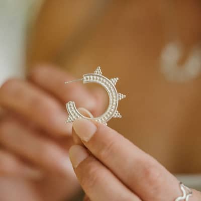 Model Holding Earrings