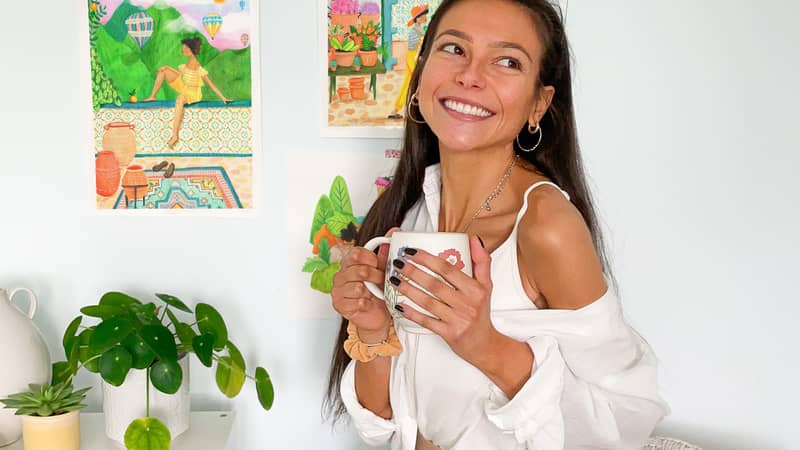 Chiara Celini, with artwork hanging on wall