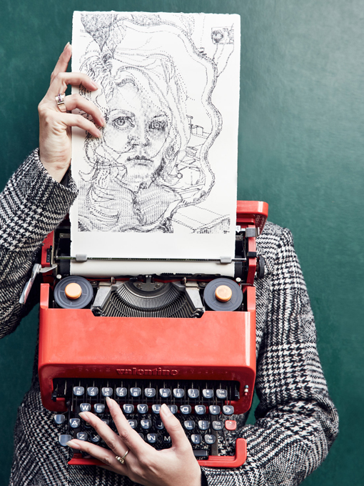 Keira Rathbone Typewriter ARtist portrait with typewriter and self portrait typewriter art work in front of face, fingers on keys and holding paper