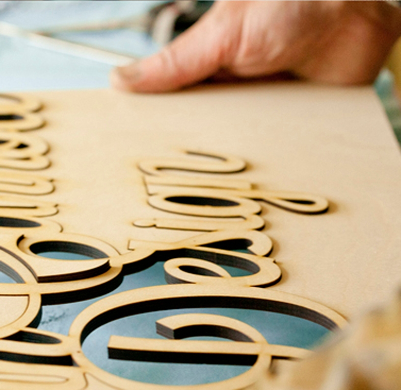 Man working on wooden sign