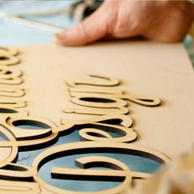 Man working on wooden sign