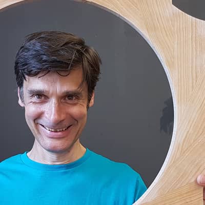 Roland's face within a mirror frame.