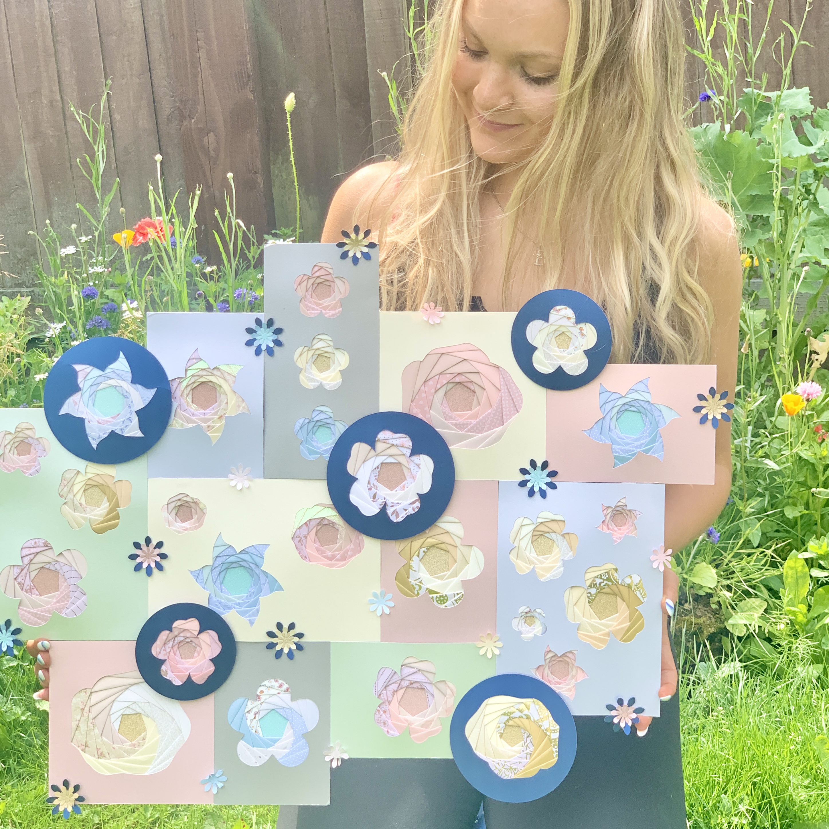 Bethan holding a large iris folded floral wall art