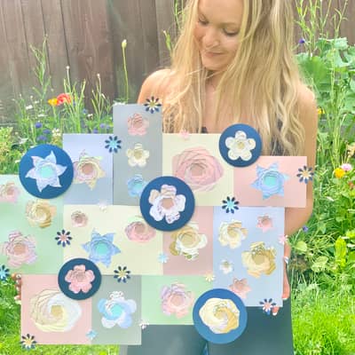 Bethan holding a large iris folded floral wall art