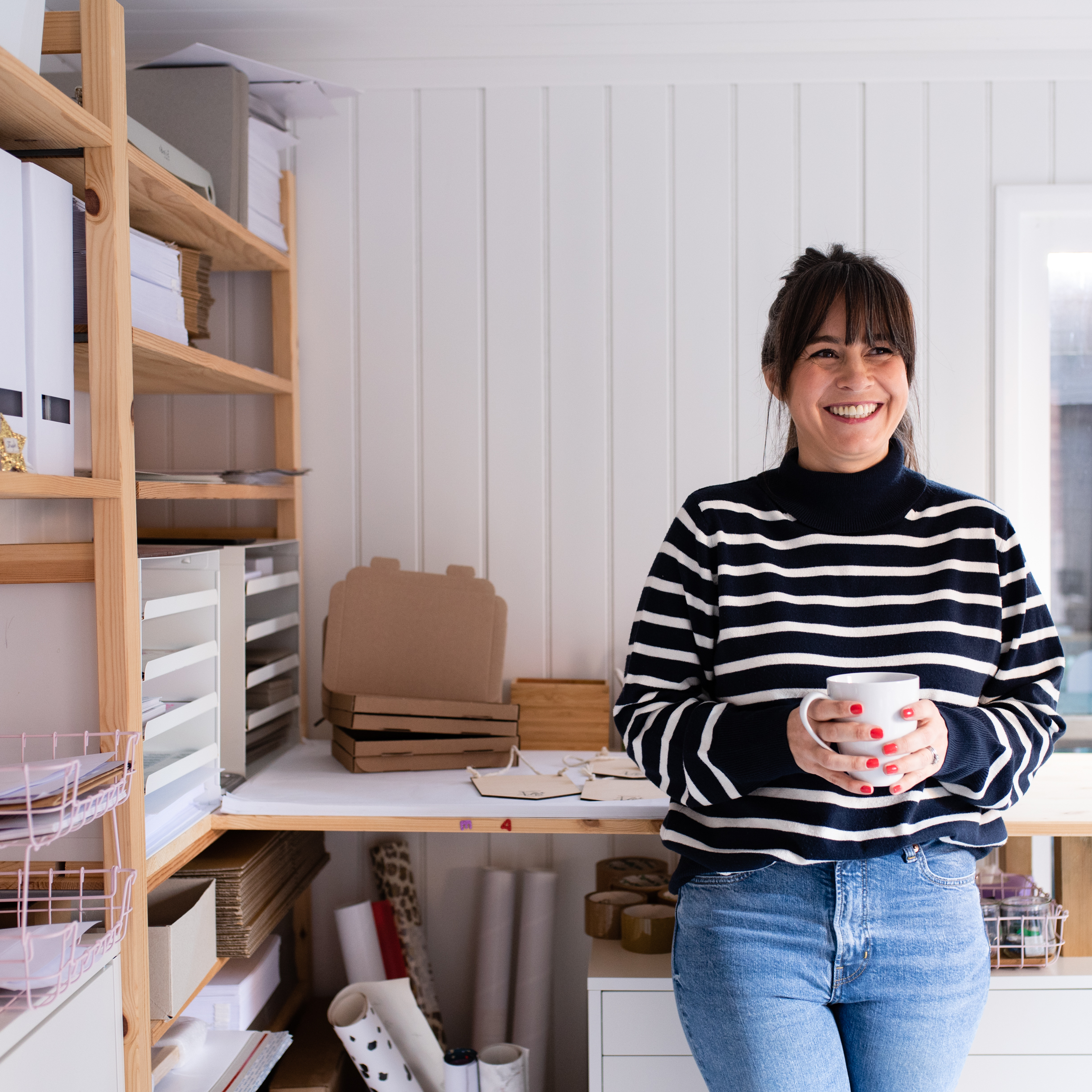 Stephanie Orr Flat102 founder in her studio holding a mug