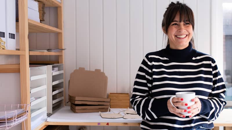 Stephanie Orr Flat102 founder in her studio holding a mug