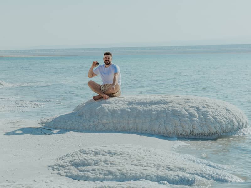 Man holding The Dead Sea Co. Mineral Mask at the Dead Sea in Jordan
