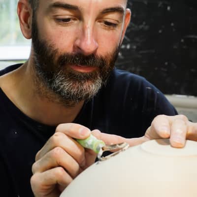 Turning a white ceramic bowl