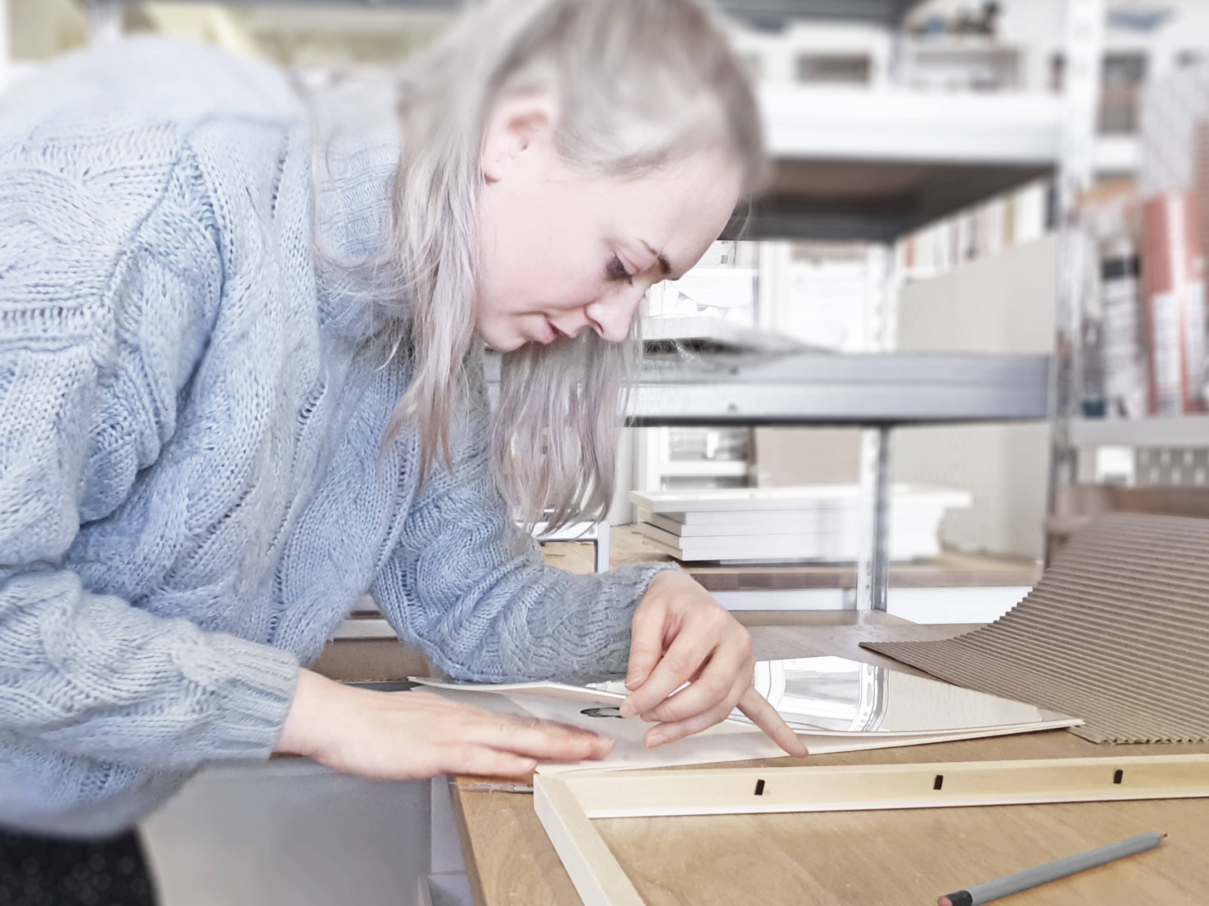 Daisy and Bump's assistant Jess hand framing one of our fine art children's prints