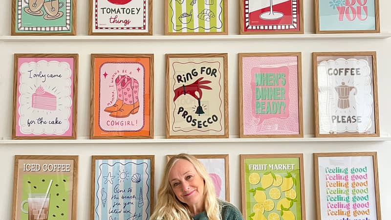 WooHoo Prints, Mandi sat under gallery wall in her studio