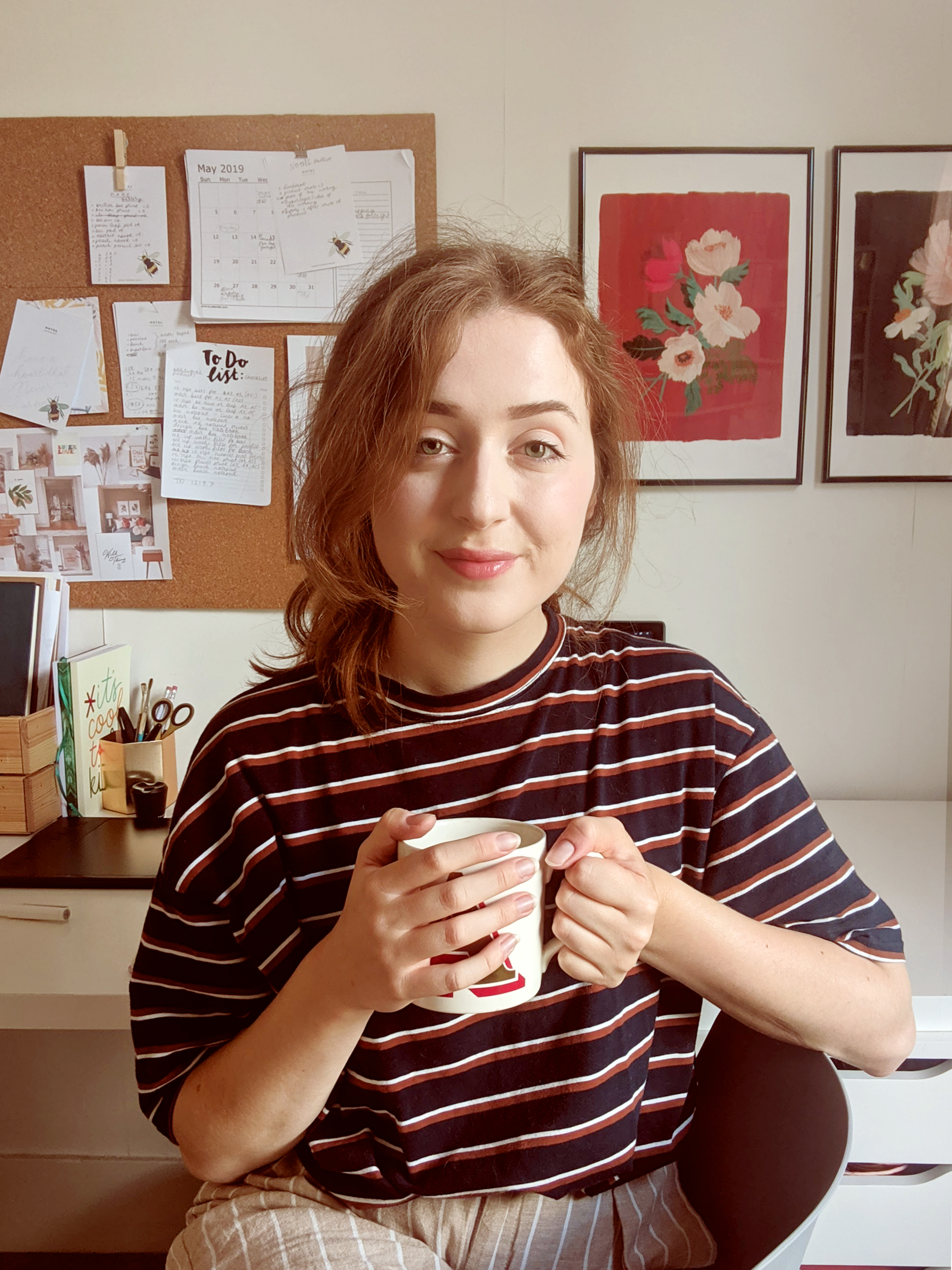 Annie, sits in here studio in the UK holding a cuppa