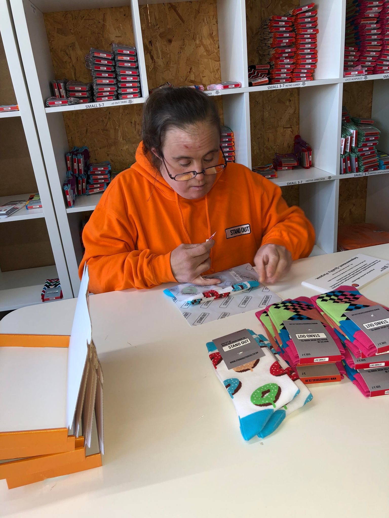 Stand Out Socks team member working hard to personally packing orders.