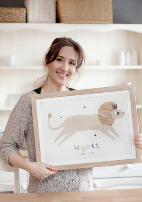 Susan holding a print and smiling