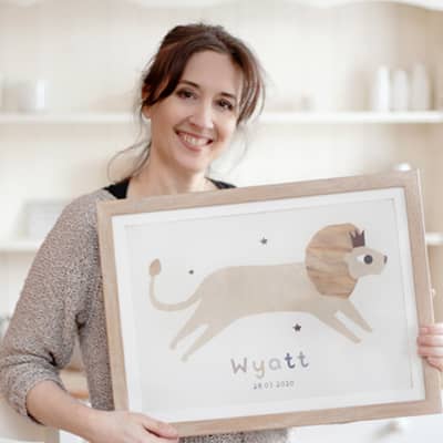 Susan holding a print and smiling