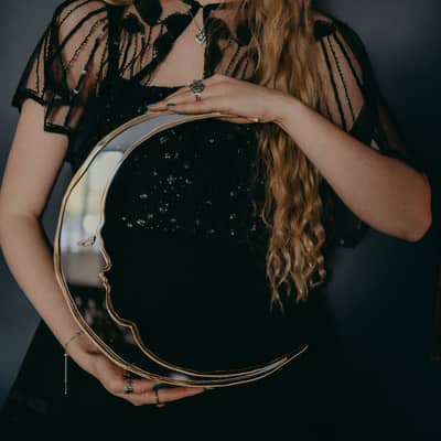 A statement mirror in the shape of a crescent moon